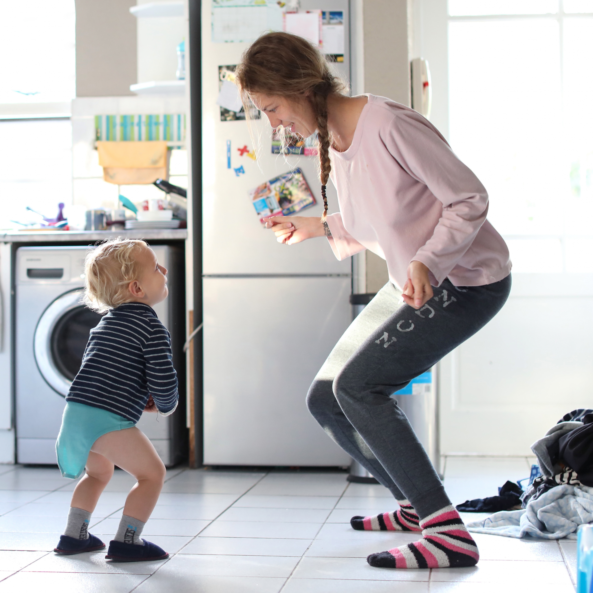 Mum dancing in the kitchen with her child