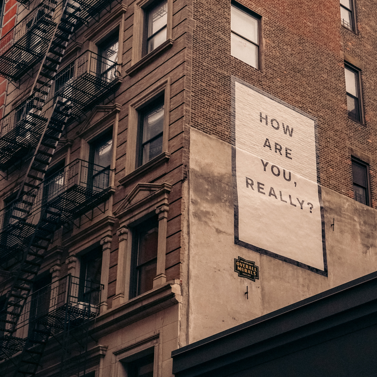 'How are you really?' sign on side of a building