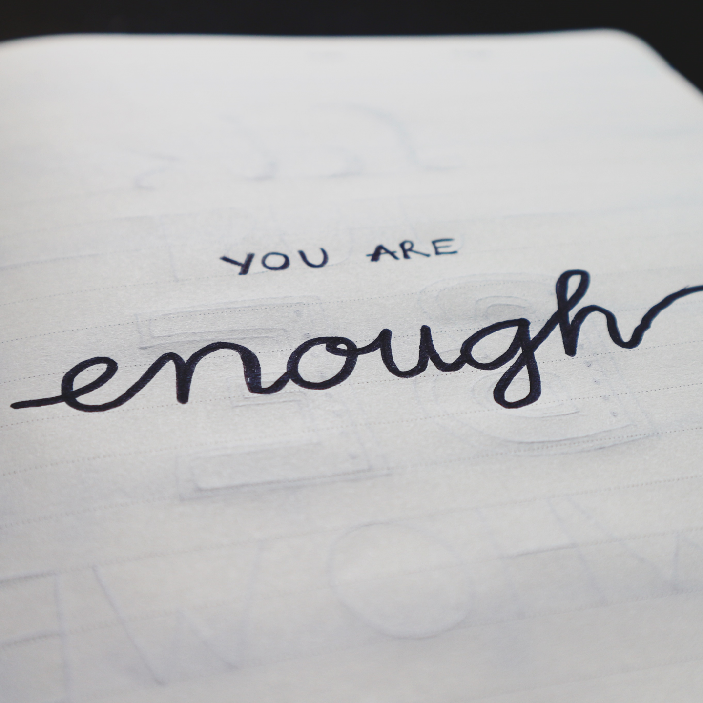 'You are enough' handwritten on paper