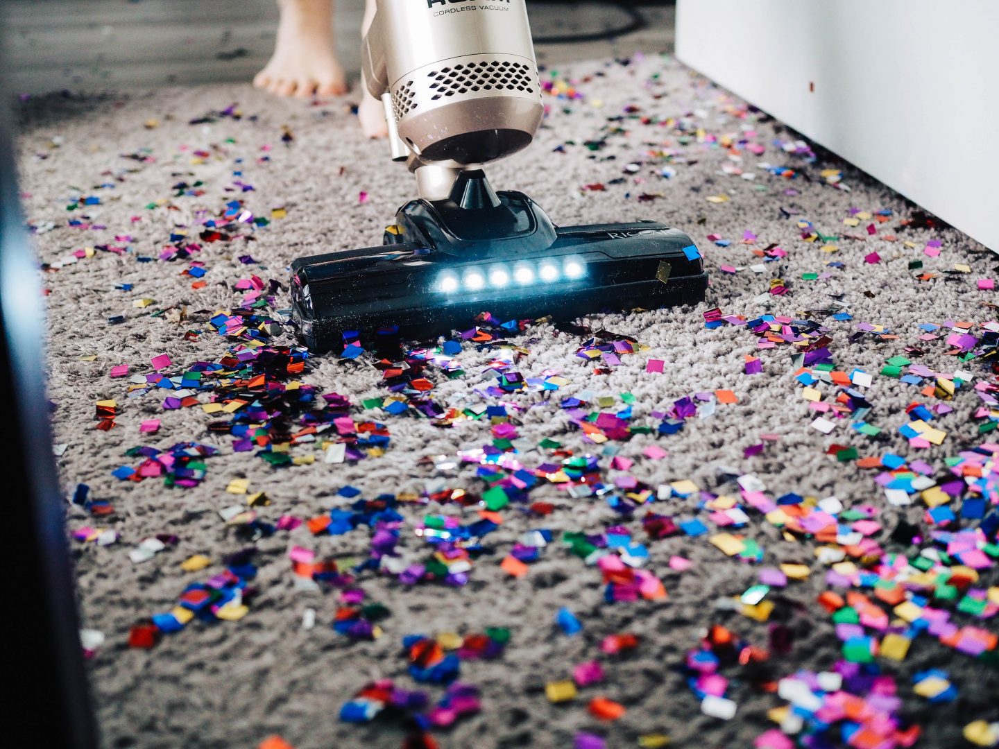 Vacuuming up glitter from a rug